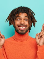 hopeful-cheerful-man-with-dreads-keeps-fingers-cro-2022-02-08-04-50-29-utc-1.jpg
