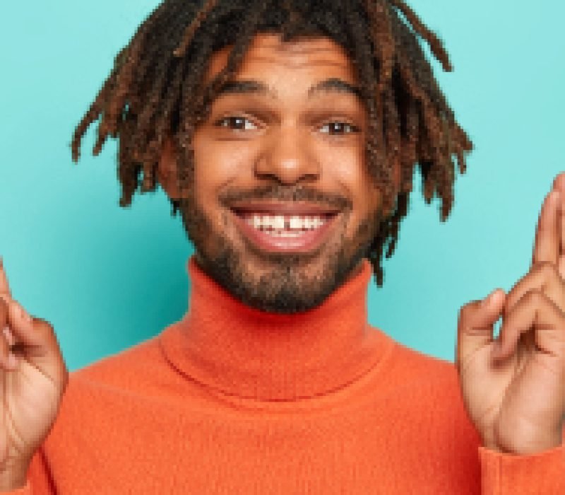hopeful-cheerful-man-with-dreads-keeps-fingers-cro-2022-02-08-04-50-29-utc-1.jpg